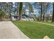 Quaint single-story house showcasing a lush green lawn and beautiful mature trees at 3970 Scott Dr, Forest Park, GA 30297