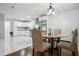 Bright kitchen featuring white cabinets, stainless steel appliances, and an adjacent dining area at 3970 Scott Dr, Forest Park, GA 30297