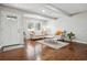 Bright living room featuring hardwood floors, natural light, and neutral furniture at 3970 Scott Dr, Forest Park, GA 30297