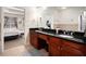 Bathroom showcasing double sinks, dark wood cabinets, and tile flooring at 600 Jardin Ct # 48, Alpharetta, GA 30022