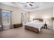 Cozy bedroom with a woven bed frame, two windows, and a ceiling fan at 600 Jardin Ct # 48, Alpharetta, GA 30022