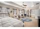 Large primary bedroom with trey ceilings, ceiling fan, sitting area, and large windows at 600 Jardin Ct # 48, Alpharetta, GA 30022