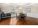 Elegant dining room with hardwood floors, wainscoting, and a modern chandelier at 600 Jardin Ct # 48, Alpharetta, GA 30022