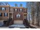 Charming brick townhome with two-car garage and inviting front entrance with black iron railings and American flags at 600 Jardin Ct # 48, Alpharetta, GA 30022