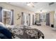 Bright main bedroom showcasing neutral walls, private balcony, and plush carpeting at 600 Jardin Ct # 48, Alpharetta, GA 30022