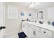 Bright bathroom with double sinks and large mirror at 7545 Rambling Vale, Cumming, GA 30028