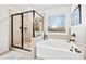 Bright bathroom with separate soaking tub and glass enclosed shower at 7545 Rambling Vale, Cumming, GA 30028