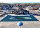Community pool covered for the off-season, surrounded by a fence, clubhouse, and other neighborhood residences at 7545 Rambling Vale, Cumming, GA 30028