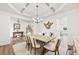 Well-lit dining area showcasing coffered ceilings and an open layout with easy access to the kitchen at 7545 Rambling Vale, Cumming, GA 30028