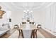 Elegant dining room with coffered ceilings, modern chandelier, and ample seating for formal gatherings at 7545 Rambling Vale, Cumming, GA 30028