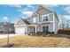 Attractive exterior showcasing a well-manicured lawn and inviting architectural style with a two-car garage at 7545 Rambling Vale, Cumming, GA 30028