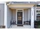 Close-up of the home's entryway, featuring a stylish front door, elegant details, and a welcoming porch at 7545 Rambling Vale, Cumming, GA 30028