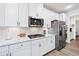 Modern kitchen showcasing stainless steel appliances, white cabinets, and stylish subway tile backsplash at 7545 Rambling Vale, Cumming, GA 30028