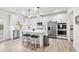 Modern kitchen with white cabinets, stainless steel appliances, and an island with seating for casual dining at 7545 Rambling Vale, Cumming, GA 30028