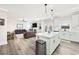 Open concept kitchen with an island, seamlessly connected to the living room area at 7545 Rambling Vale, Cumming, GA 30028
