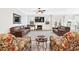 Spacious living room featuring a fireplace, plenty of seating, and an open layout with views of the backyard at 7545 Rambling Vale, Cumming, GA 30028