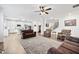 Open-concept living area featuring hardwood floors, abundant natural light, and seamless flow into the kitchen at 7545 Rambling Vale, Cumming, GA 30028