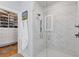 Modern shower with marble tile, glass door, and sleek fixtures, adjacent to the walk-in closet at 310 Burgess Walk, Alpharetta, GA 30009