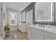 Bright bathroom featuring double sinks with modern white cabinetry and sleek black accents at 310 Burgess Walk, Alpharetta, GA 30009
