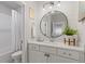 Modern bathroom features shiplap wall detail, round mirror, and a shower-tub combo at 310 Burgess Walk, Alpharetta, GA 30009