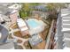 Aerial view of the community pool and outdoor seating area with brick and landscaped surroundings at 310 Burgess Walk, Alpharetta, GA 30009