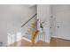 Bright entryway featuring hardwood floors, paneled walls, and staircase with wood railing at 310 Burgess Walk, Alpharetta, GA 30009