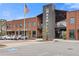 The Maxwell building exterior view featuring a brick facade, signage, parking, and modern architectural details at 310 Burgess Walk, Alpharetta, GA 30009