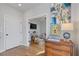 Foyer with hardwood floors leading to living area featuring colorful artwork and stylish furnishings at 310 Burgess Walk, Alpharetta, GA 30009