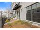 Charming townhome with a covered front entrance, featuring a garden and a black metal fence at 310 Burgess Walk, Alpharetta, GA 30009