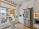 Bright kitchen nook with large window, stylish decor, and stainless steel refrigerator at 310 Burgess Walk, Alpharetta, GA 30009