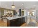 Spacious kitchen island with marble countertop adjacent to a dining area at 310 Burgess Walk, Alpharetta, GA 30009