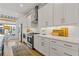 Well-lit kitchen features stainless steel appliances, white cabinets, and hardwood floors at 310 Burgess Walk, Alpharetta, GA 30009