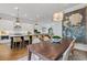 Open-concept dining and kitchen with hardwood floors and modern fixtures at 310 Burgess Walk, Alpharetta, GA 30009