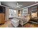 Charming main bedroom featuring a comfortable bed, ceiling fan, and bedside furniture at 310 Burgess Walk, Alpharetta, GA 30009