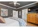 Comfortable bedroom featuring a queen bed, warm lighting, and ensuite bathroom at 310 Burgess Walk, Alpharetta, GA 30009