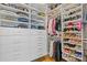 Spacious walk-in closet featuring custom shelving, ample storage and organizational solutions at 310 Burgess Walk, Alpharetta, GA 30009