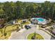Aerial view of the community pool, clubhouse, garden plots, and well manicured landscaping at 520 Clover Ln, Alpharetta, GA 30009