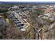 Aerial view of a community with modern townhomes, a pool, and walking paths at 520 Clover Ln, Alpharetta, GA 30009