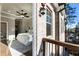 View from balcony into the primary bedroom with hardwood floors and large bed at 520 Clover Ln, Alpharetta, GA 30009