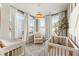 Cozy Bedroom showcases two cribs, a comfy chair, and a large window with natural light at 520 Clover Ln, Alpharetta, GA 30009