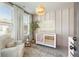 Sunlit Bedroom featuring plush seating, a stylish crib, and delightful decor at 520 Clover Ln, Alpharetta, GA 30009