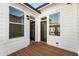 Cozy outdoor deck area with wood flooring, windows, and an open door at 520 Clover Ln, Alpharetta, GA 30009