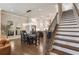 Open concept dining room with modern chandelier, hardwood floors, and staircase at 520 Clover Ln, Alpharetta, GA 30009