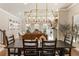 Dining room featuring hardwood floors, an elegant chandelier, and a view of the living room at 520 Clover Ln, Alpharetta, GA 30009