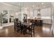 Open concept dining room with large table, hardwood floors, and view of the kitchen at 520 Clover Ln, Alpharetta, GA 30009