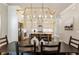 Dining room with chandelier adjacent to kitchen, stainless appliances, and kitchen island at 520 Clover Ln, Alpharetta, GA 30009