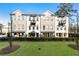 Well-manicured lawn with townhomes featuring porches and balconies at 520 Clover Ln, Alpharetta, GA 30009