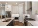Bright kitchen with white cabinets, stainless appliances, subway tile backsplash, and center island at 520 Clover Ln, Alpharetta, GA 30009