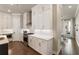Modern kitchen featuring white cabinets, stainless steel appliances, quartz countertops, and hardwood floors at 520 Clover Ln, Alpharetta, GA 30009