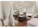 Open concept kitchen with dark island, stainless appliances, quartz counters, and hardwood floors at 520 Clover Ln, Alpharetta, GA 30009